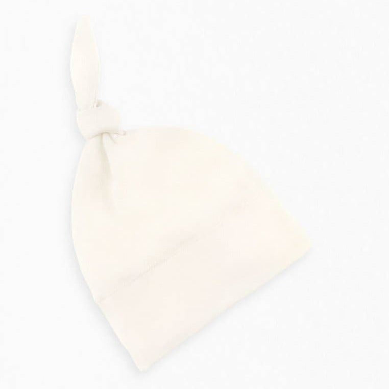 Cream cotton baby hat with knotted top