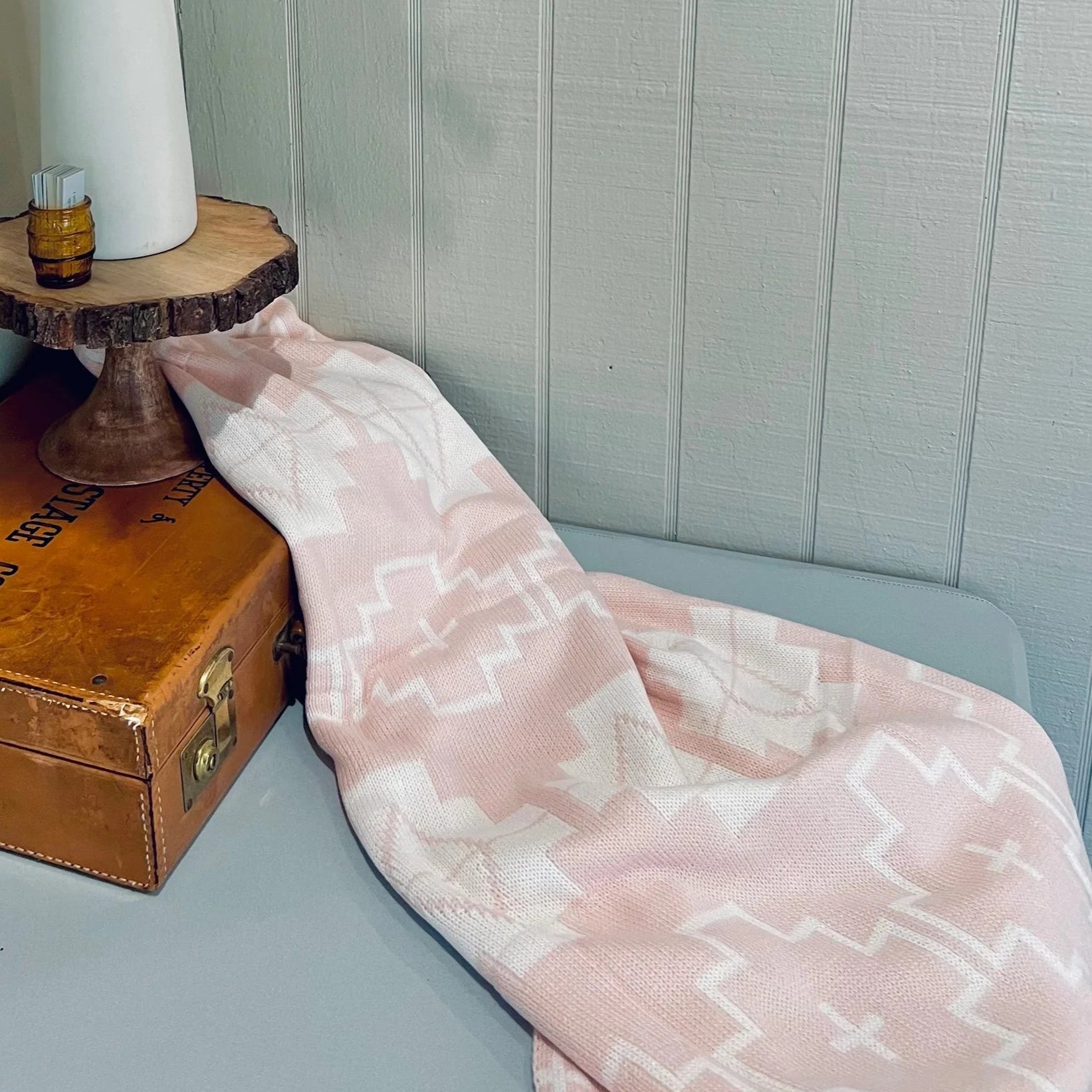 Pink and white patterned blanket.