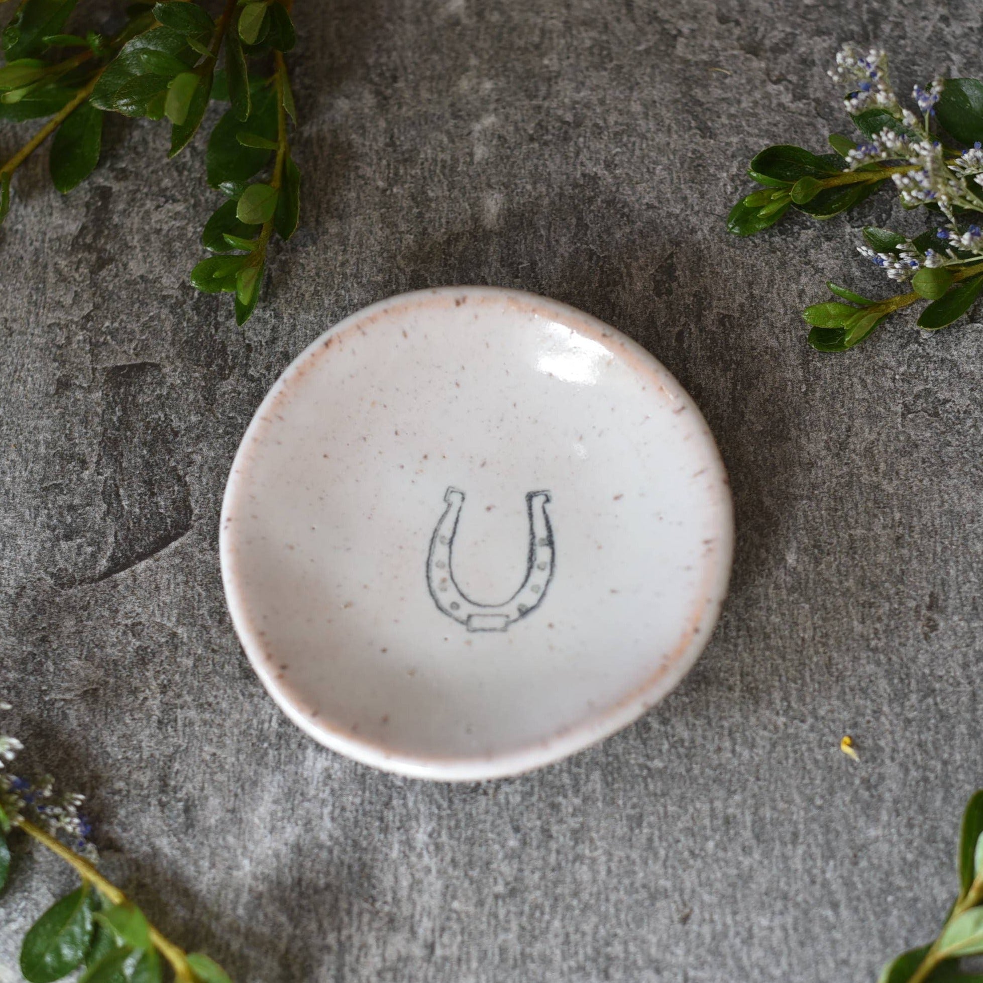 Small deep circle dish with horse shoe printed in center