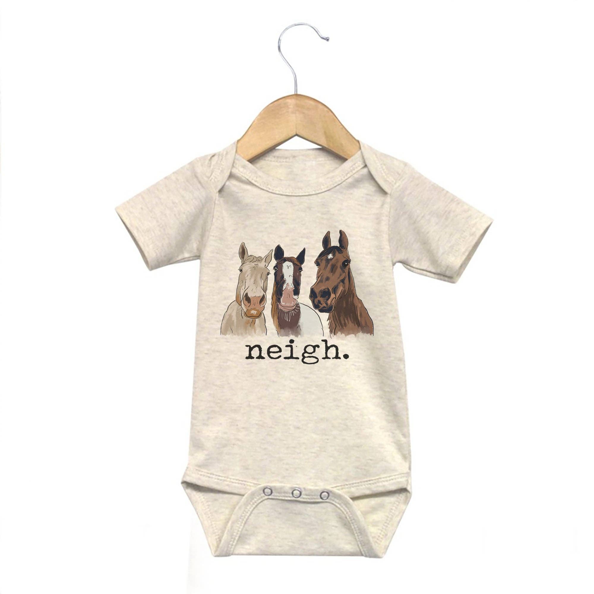 Cream baby bodysuit with the graphic of three horses and the text "neigh."